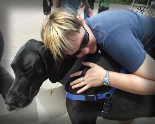 Student hugging Happy the Therapy Dog